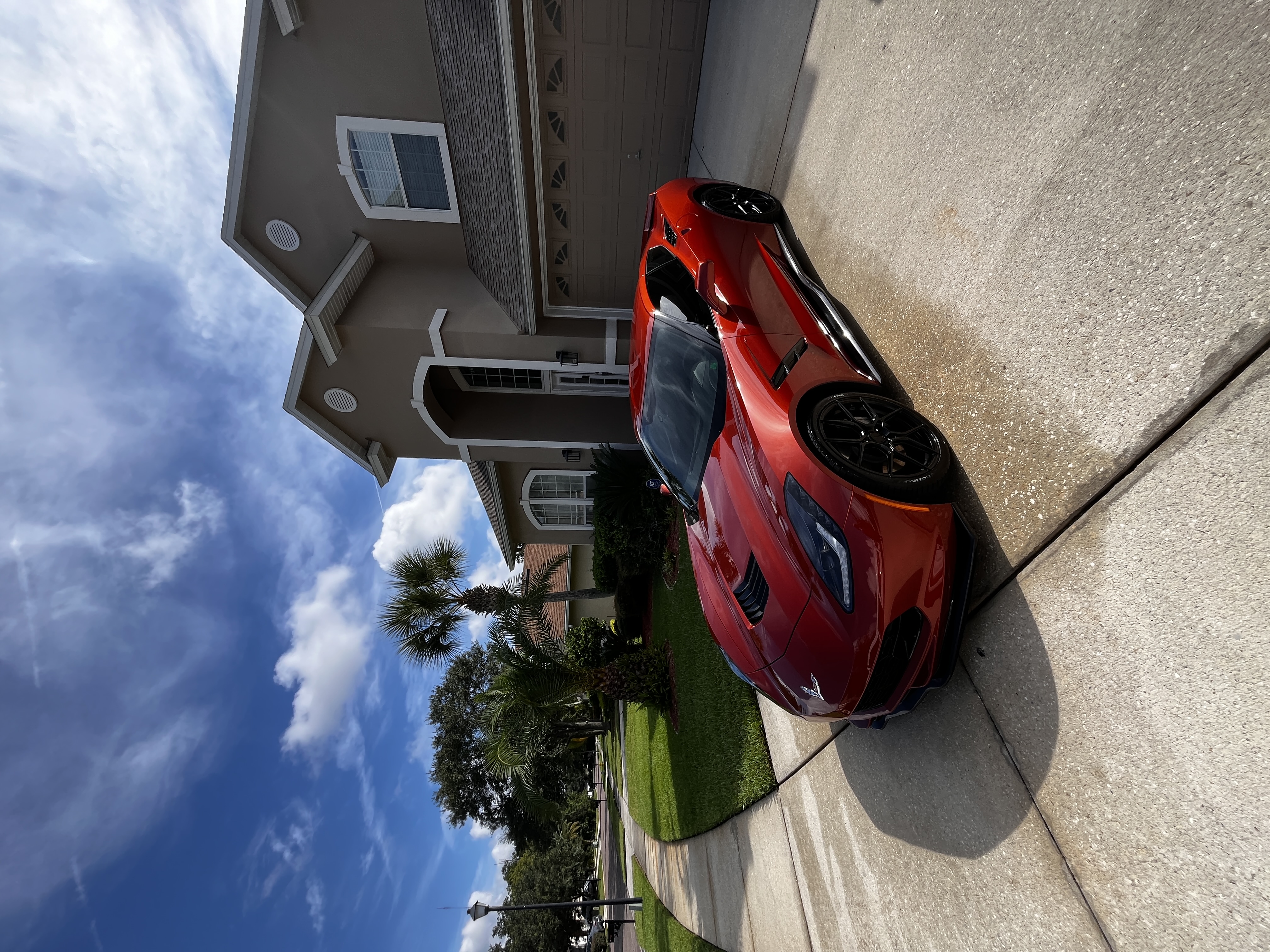 Red Corvette freshly detailed and shining on a driveway